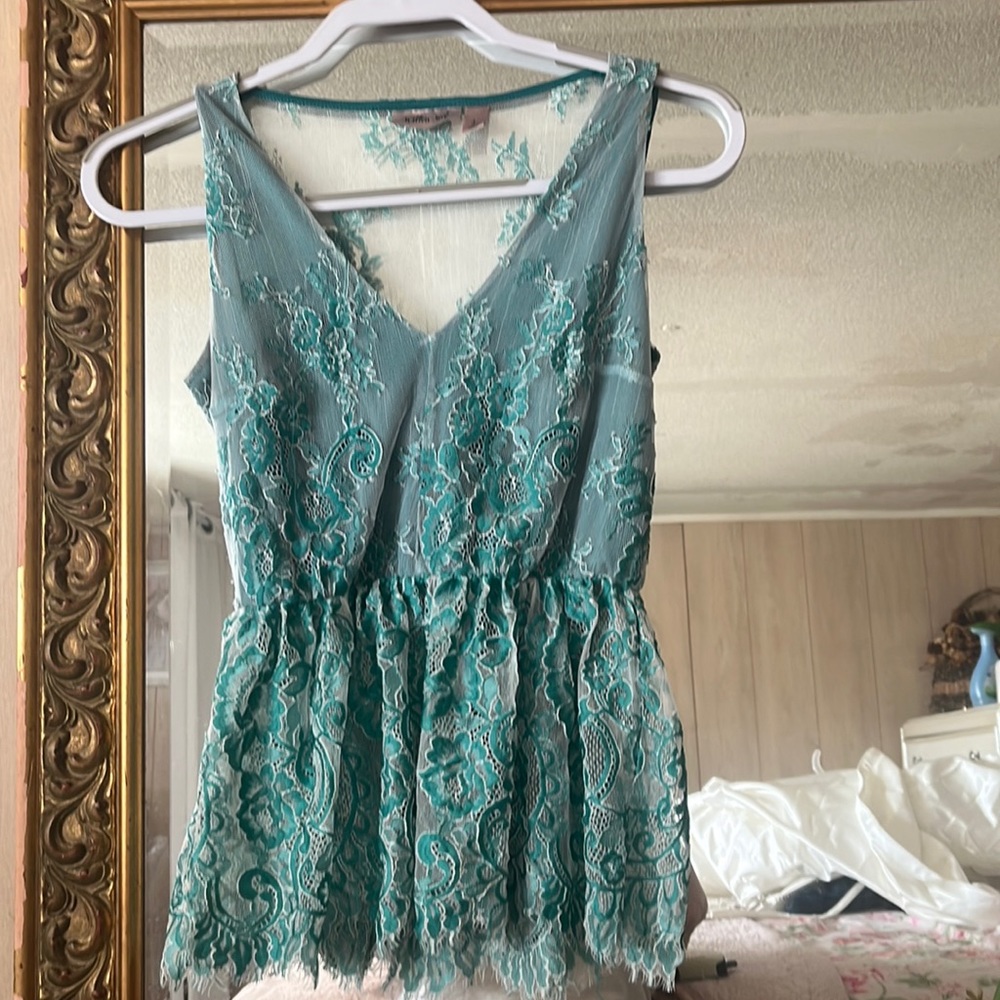 Must have for Spring!!!! Teal sleeveless floral peplum blouse. Lined in front.